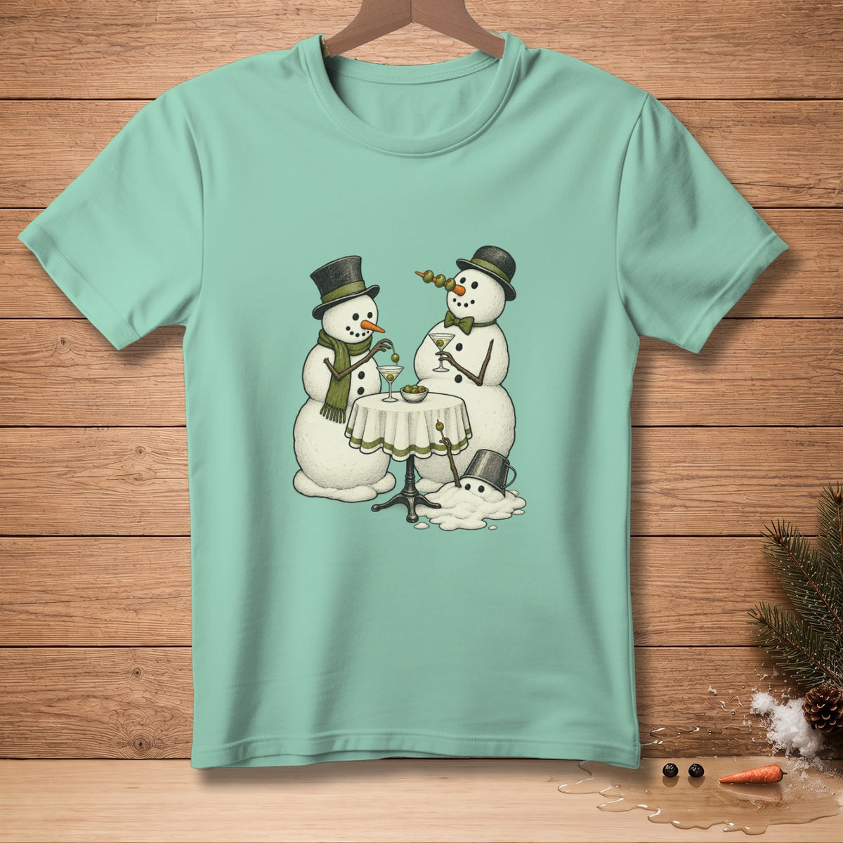 Two snowmen with top hats and scarves drinking martinis at a table with a melting snowman.