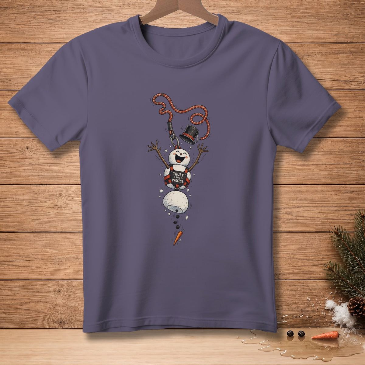 T-shirt with a falling snowman graphic that says "Trust the Process."