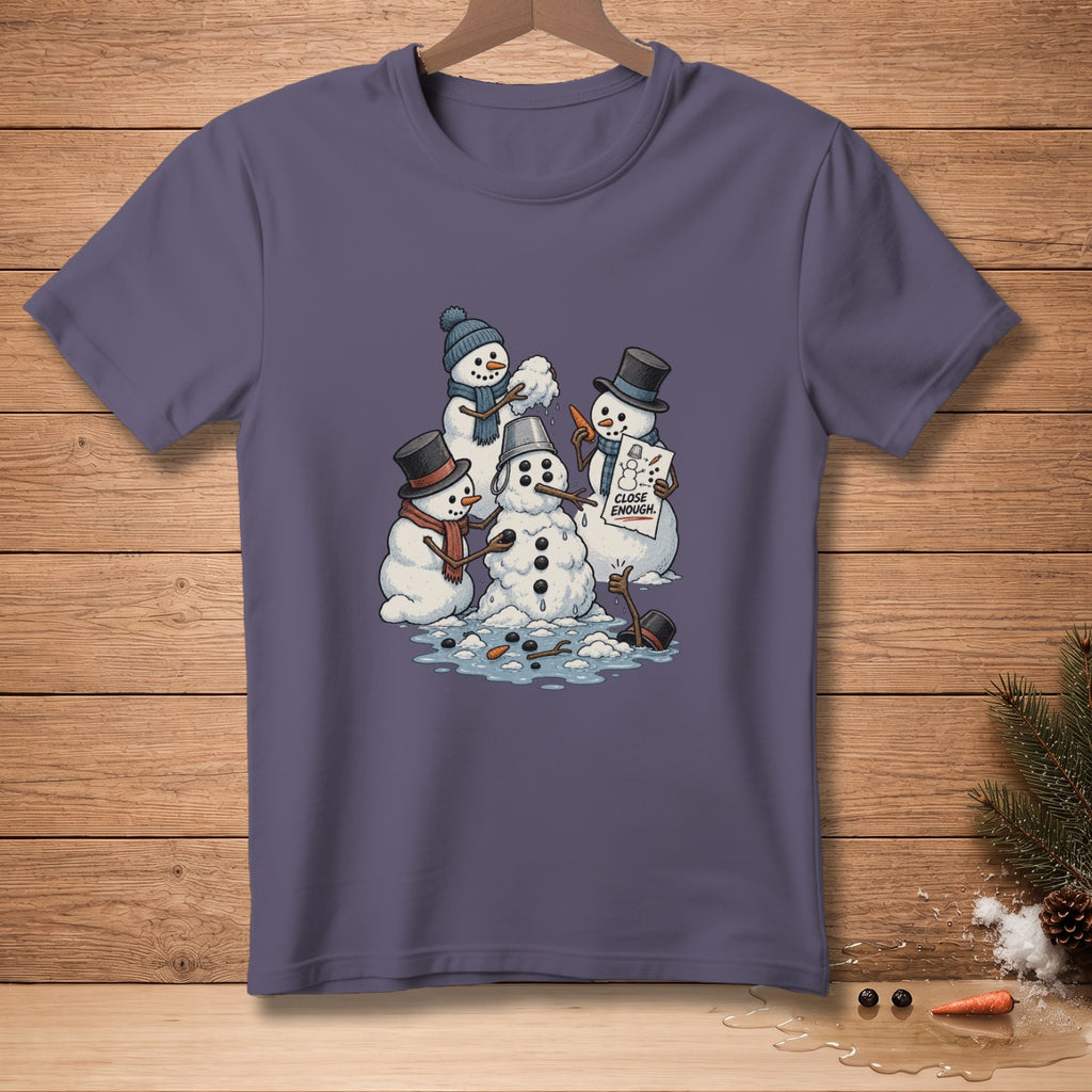 Cartoon snowmen building a snowman holding a sign that reads "CLOSE ENOUGH."