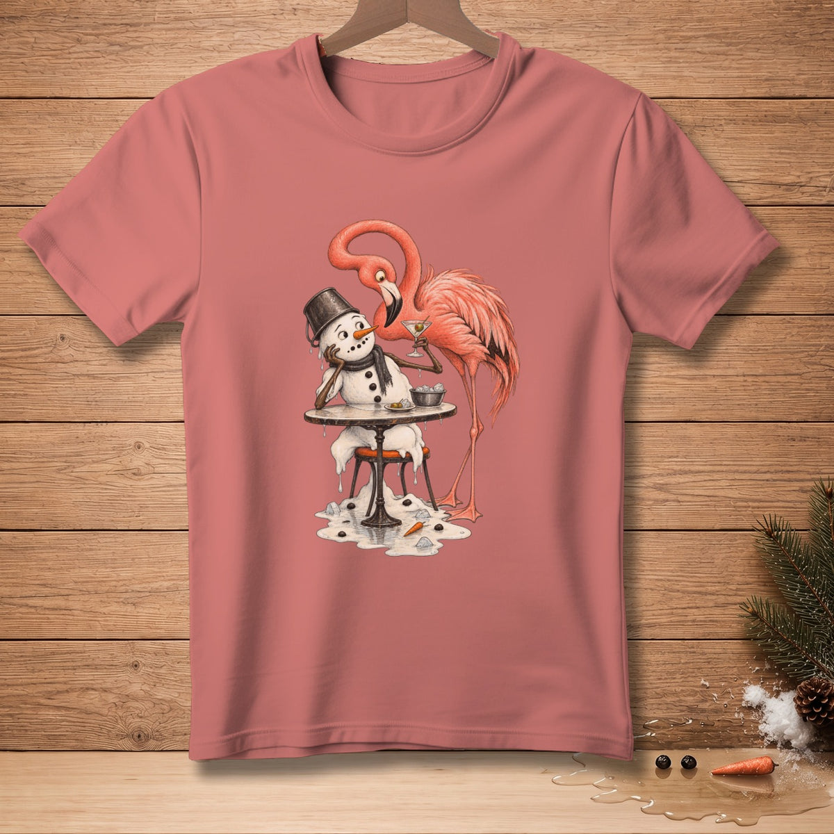 Pink t-shirt with cartoon of a flamingo offering a drink to a melting snowman.