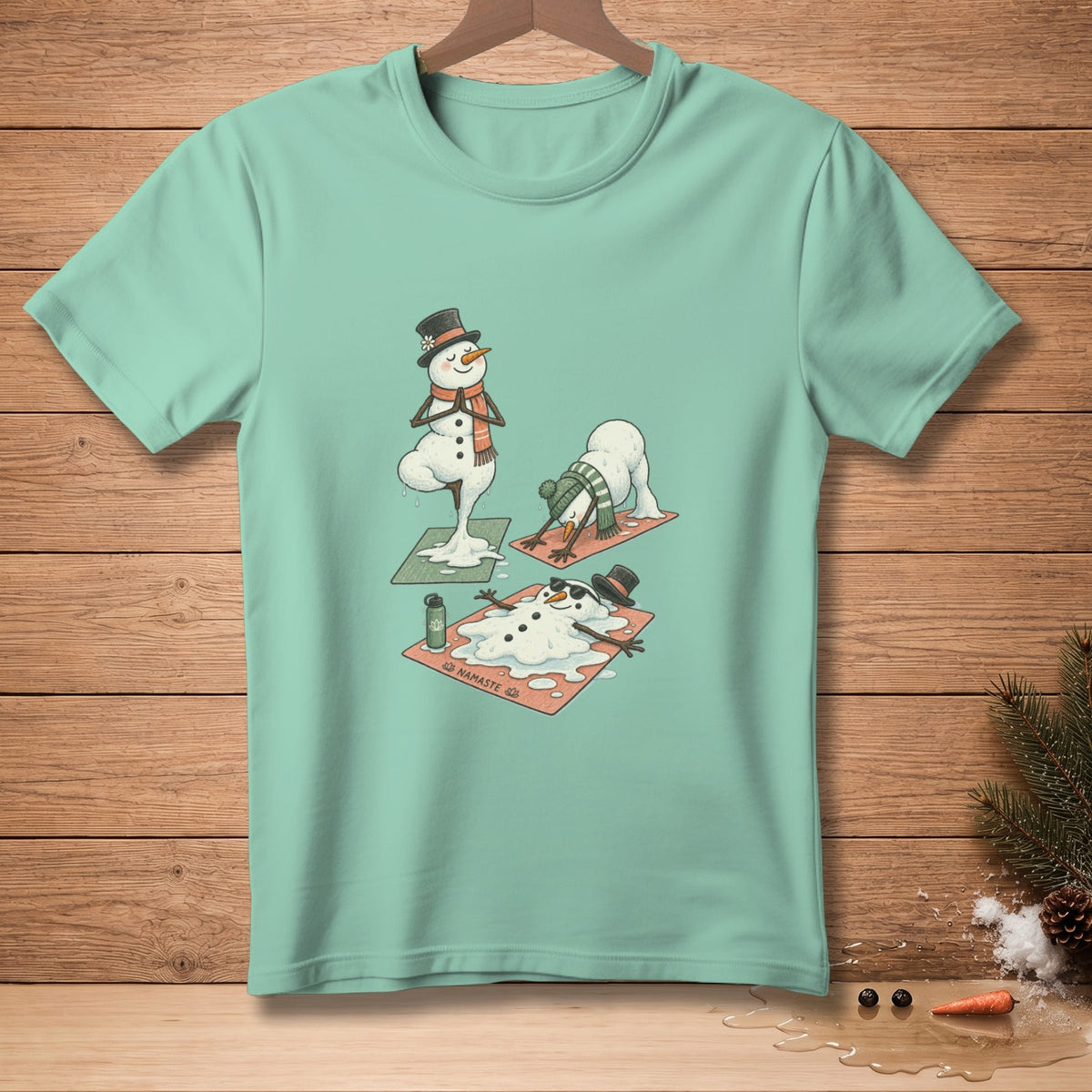 T-shirt with cartoon snowmen doing yoga and melting on mats.