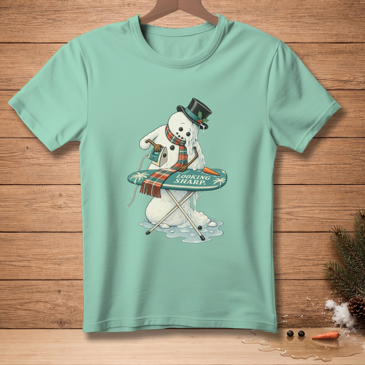 Melting snowman ironing his scarf with "LOOKING SHARP" text.