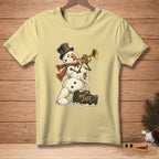 Snowman playing trumpet with "Hot Jazz" suitcase on light yellow t-shirt.