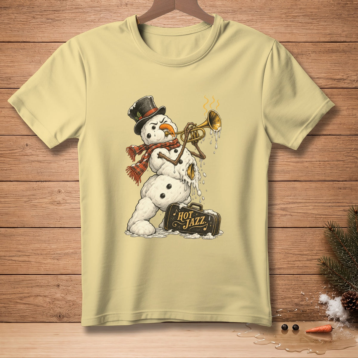 Snowman playing trumpet with "Hot Jazz" suitcase on light yellow t-shirt.
