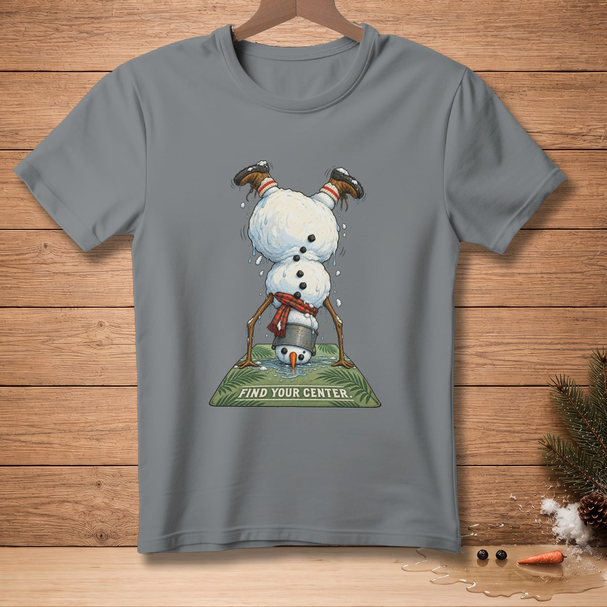 Gray t-shirt featuring a snowman doing a handstand on a yoga mat with text.