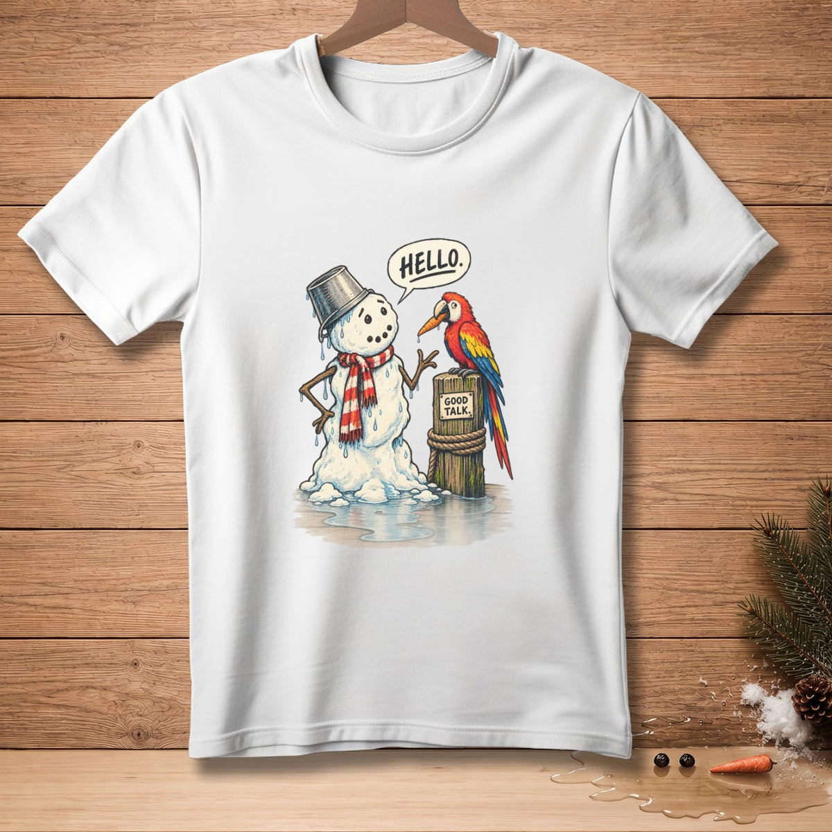 White t-shirt with a snowman and parrot illustration. Snowman says "HELLO.", parrot says "GOOD TALK."
