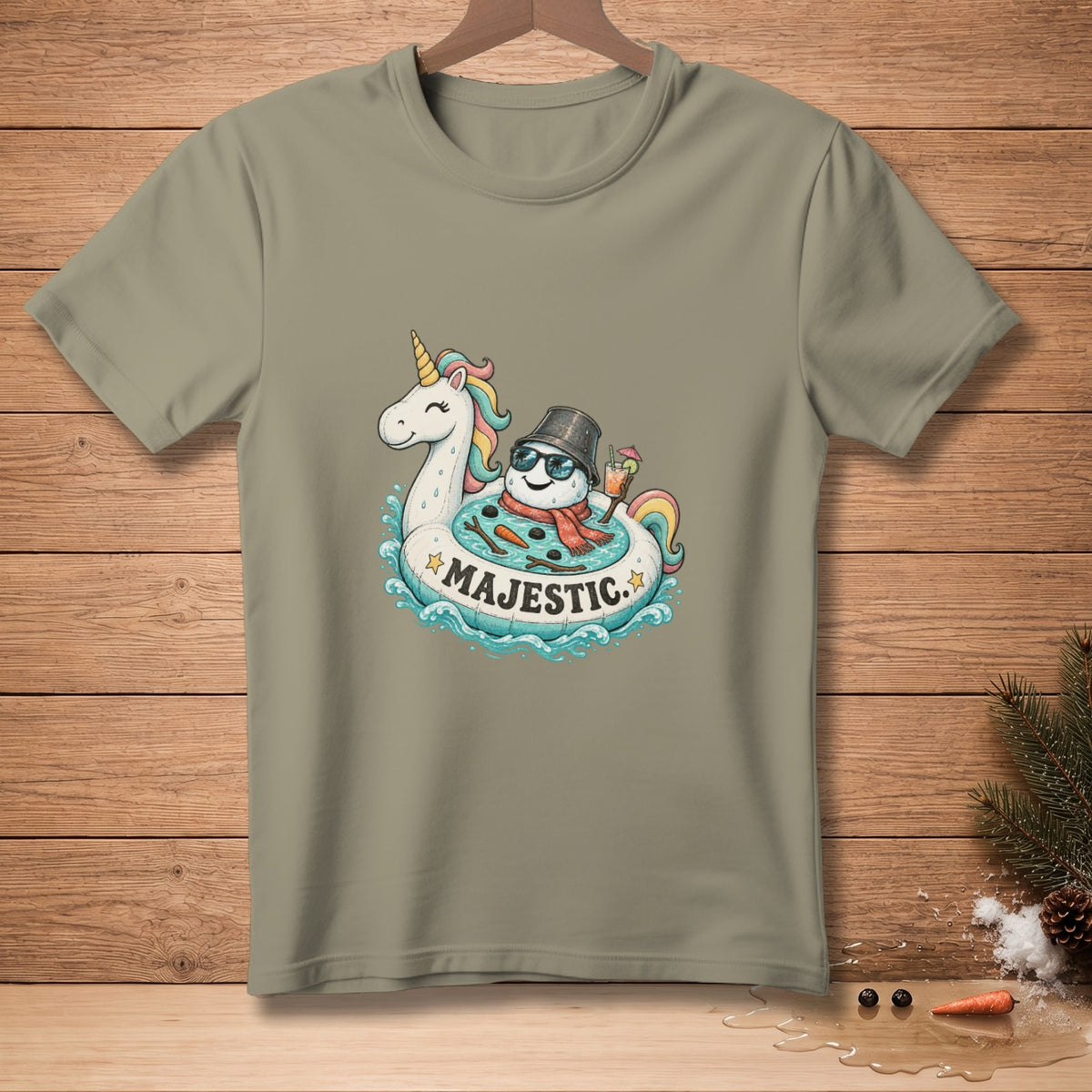 T-shirt with a cartoon of a snowman on a unicorn float, with "MAJESTIC" text.