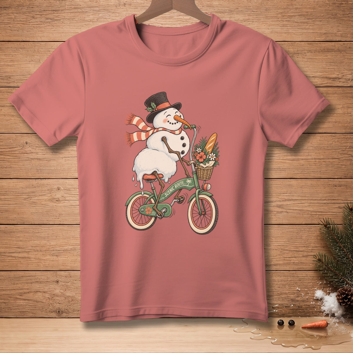Snowman with top hat and scarf riding a bicycle with a basket of bread and flowers.