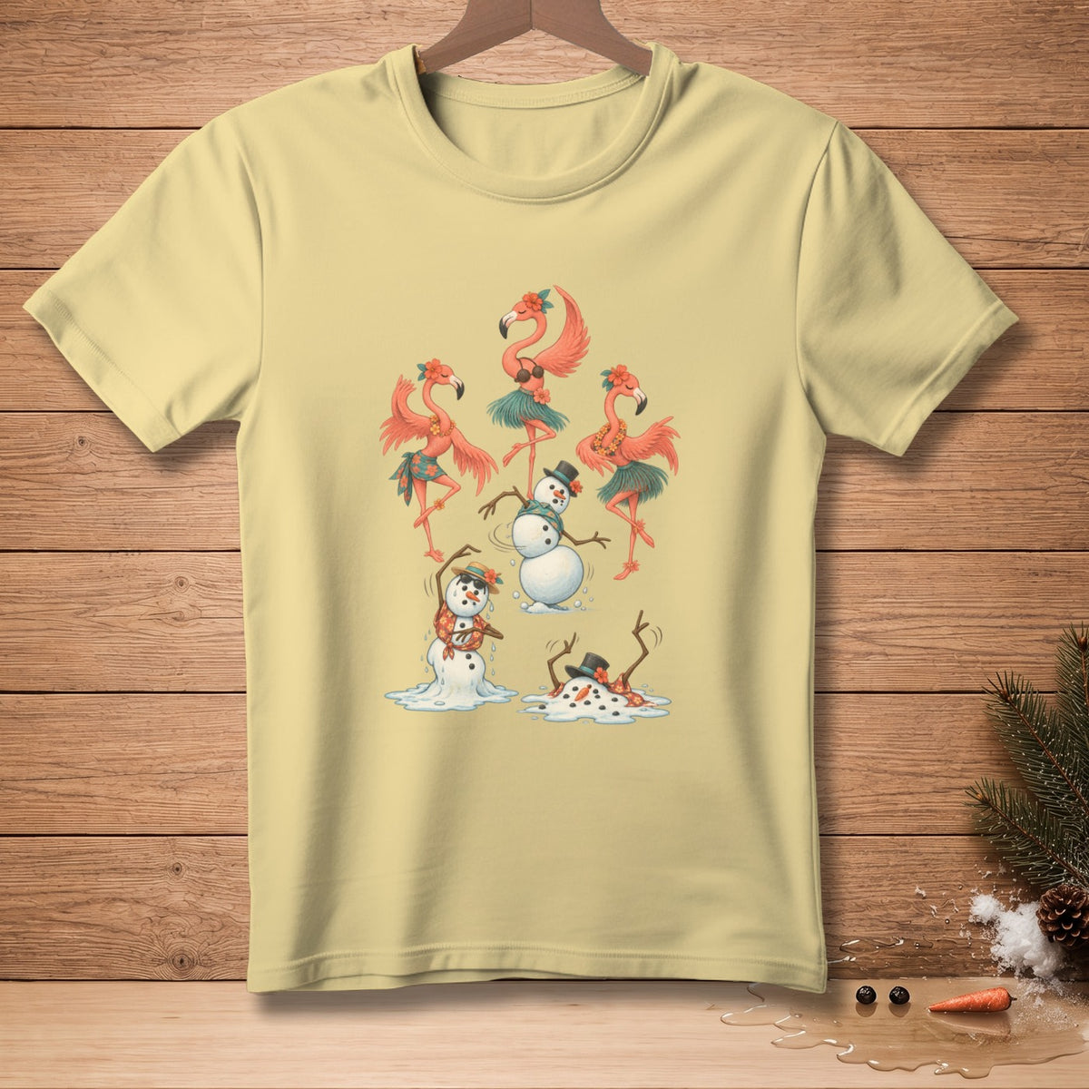 Light yellow t-shirt with dancing flamingos and melting snowmen graphic.