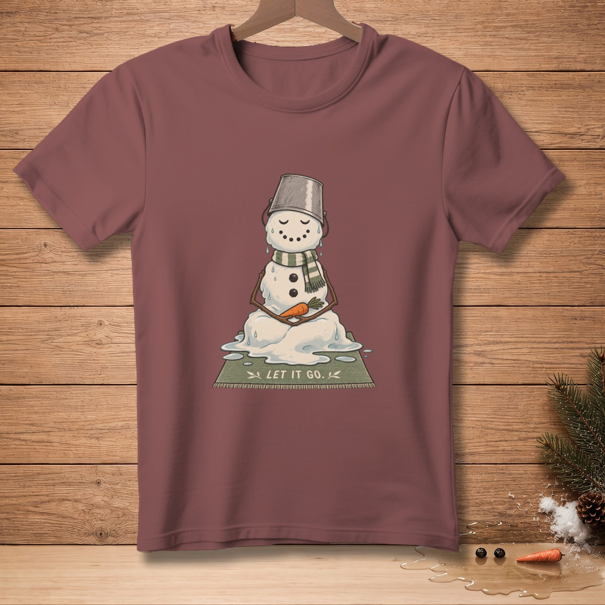 Melting snowman wearing bucket hat and scarf, holding carrot, text "LET IT GO".