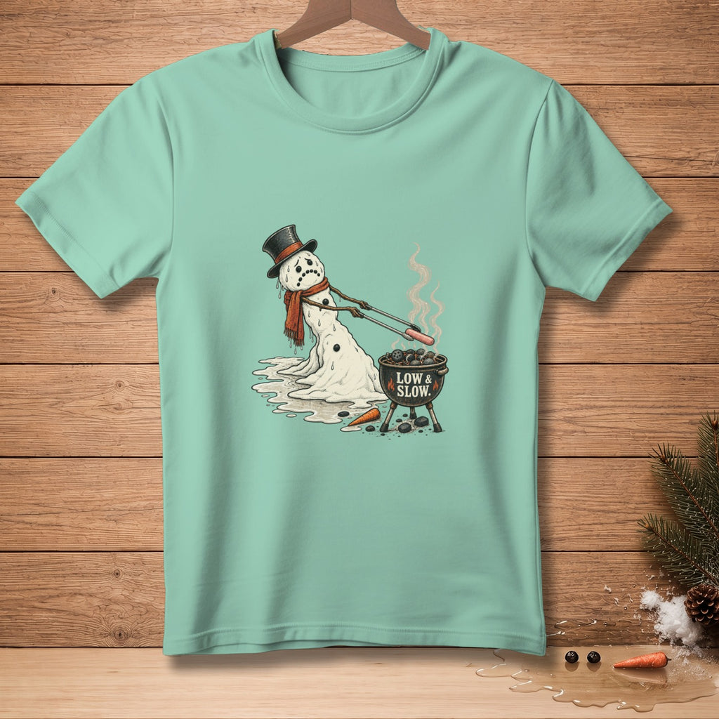 Melting snowman wearing hat and scarf grilling hot dogs with text "LOW & SLOW."