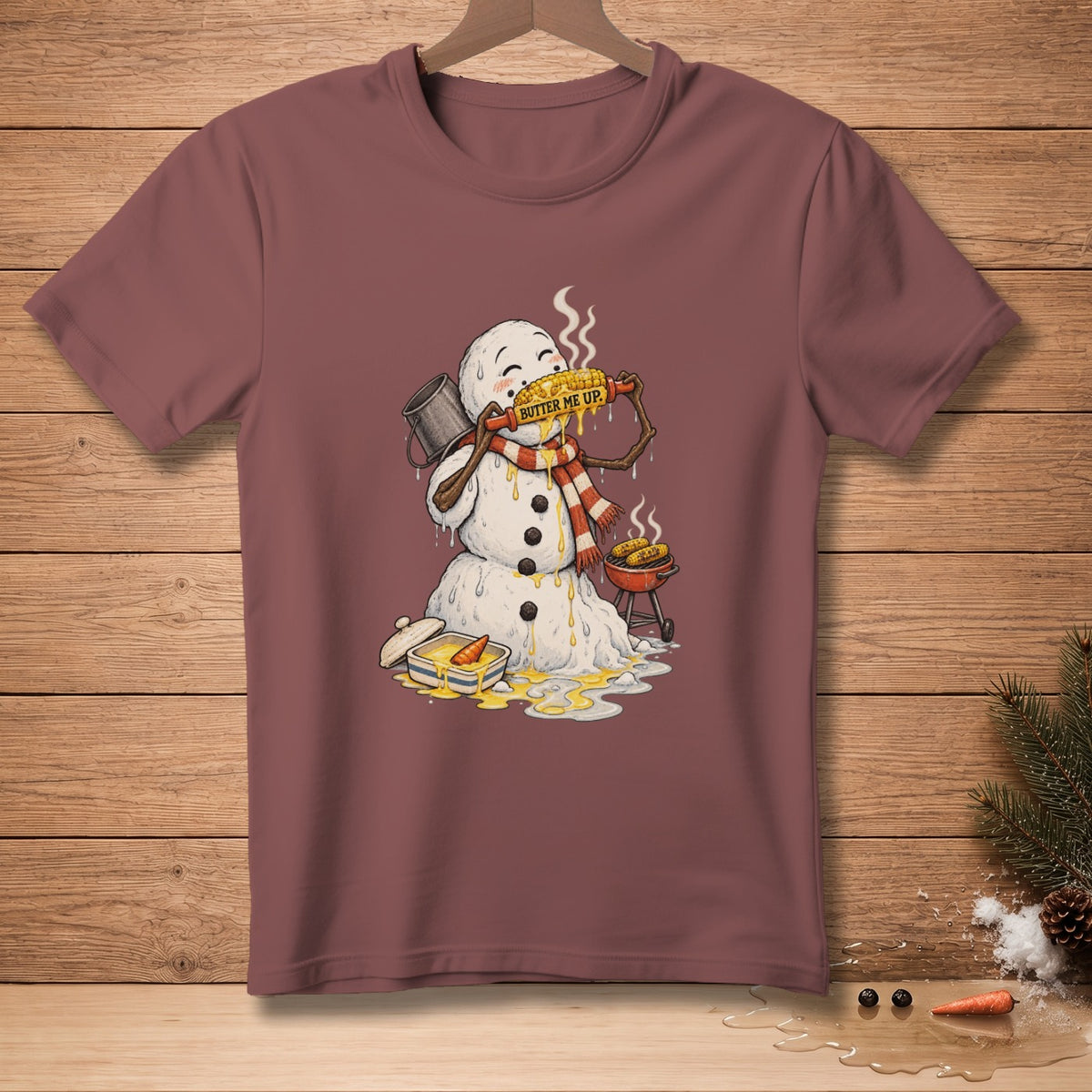 Melting snowman eating corn on the cob, text "BUTTER ME UP".
