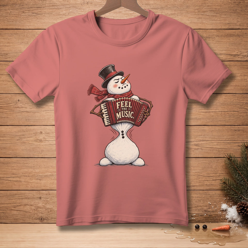 Snowman playing an accordion with "Feel the Music" text on a pink t-shirt.