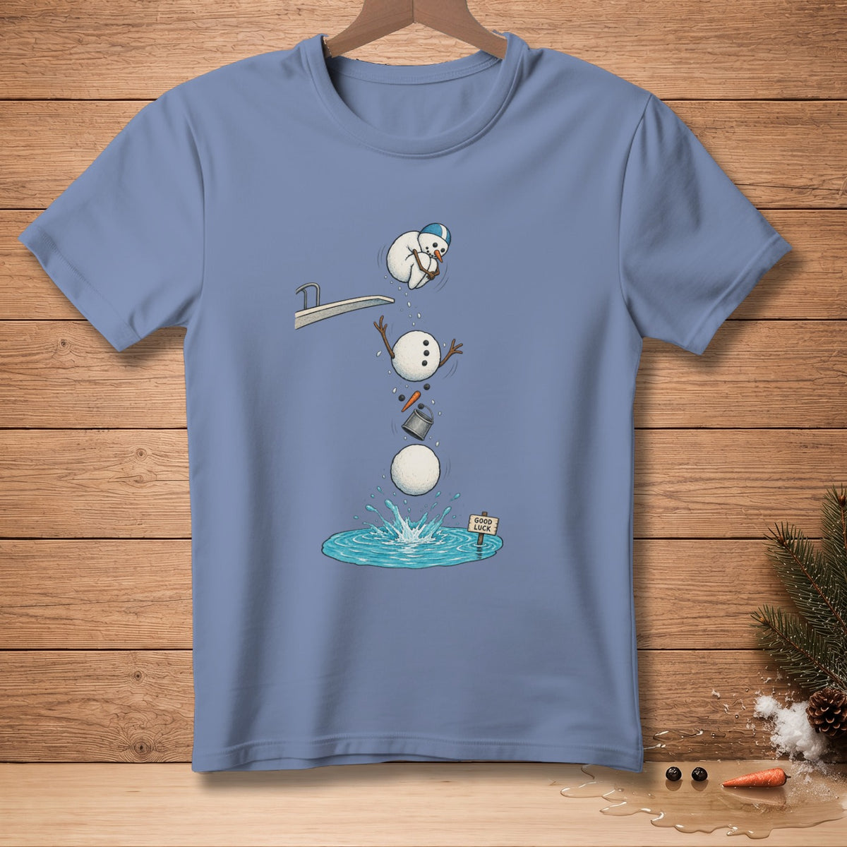 Blue t-shirt with cartoon of a snowman diving into water with "Good Luck" sign.