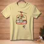 Light yellow t-shirt with snowmen on a ski lift with "WRONG SEASON" text.