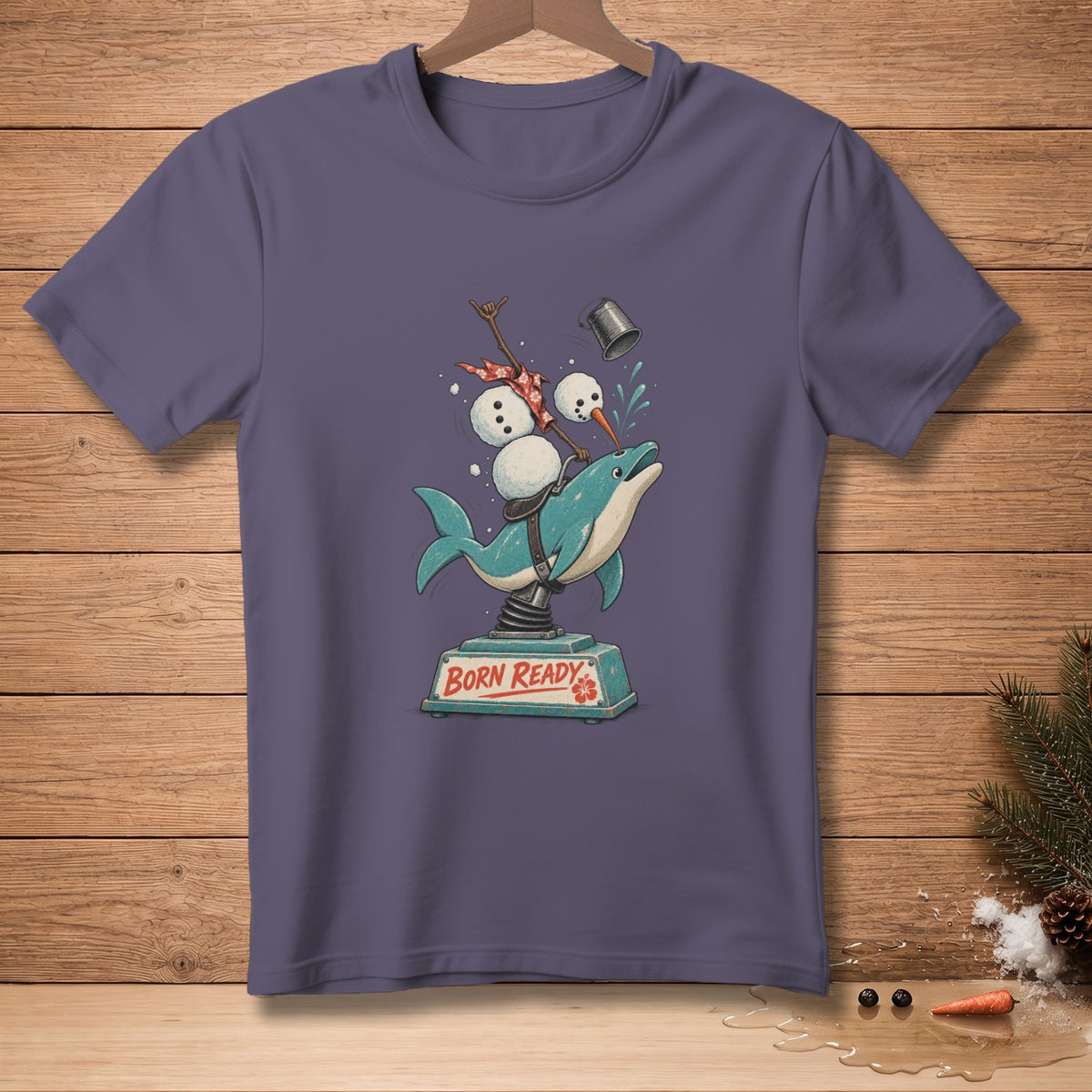 T-shirt graphic of snowman on a bucking dolphin with "BORN READY" text.