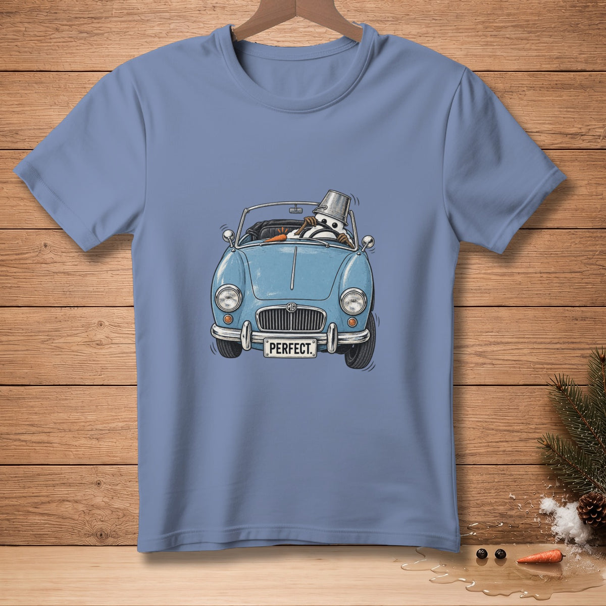 Blue t-shirt with a cartoon snowman driving a classic convertible car.