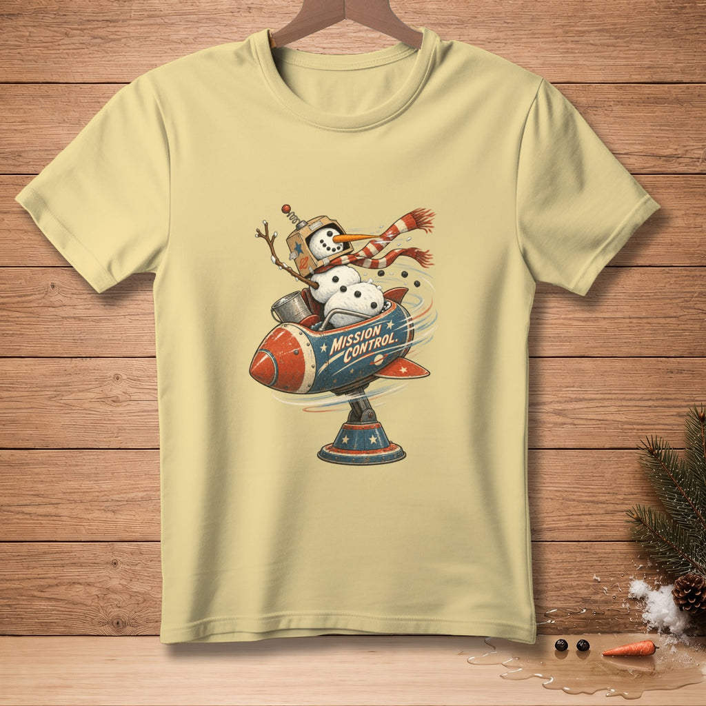 Snowman in a rocket with "MISSION CONTROL" text on a light yellow t-shirt.