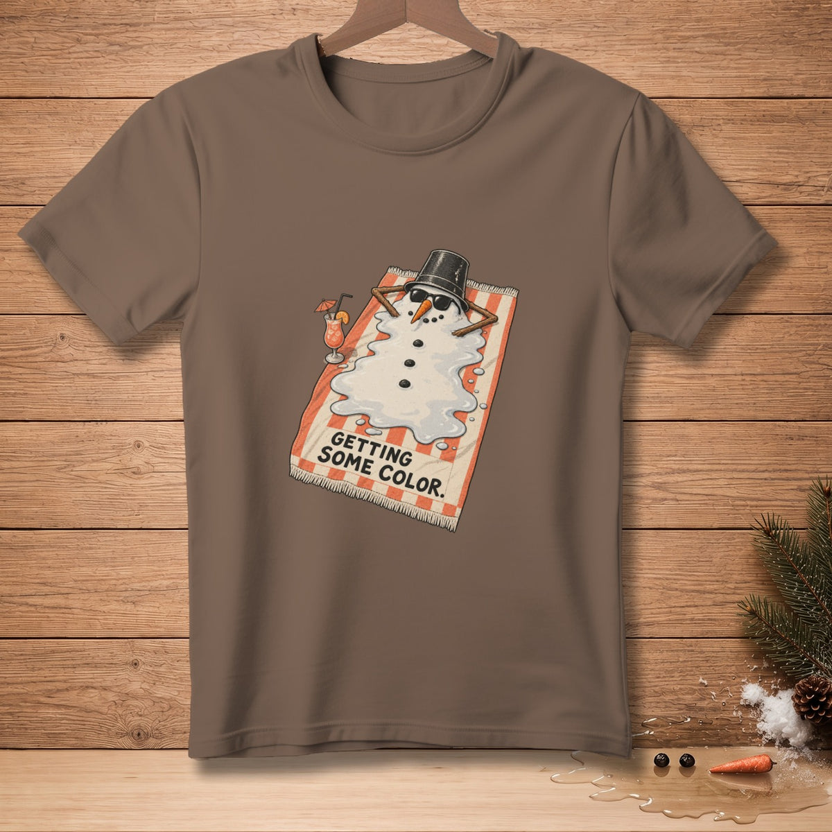 Brown t-shirt with a melting snowman graphic that says "GETTING SOME COLOR."