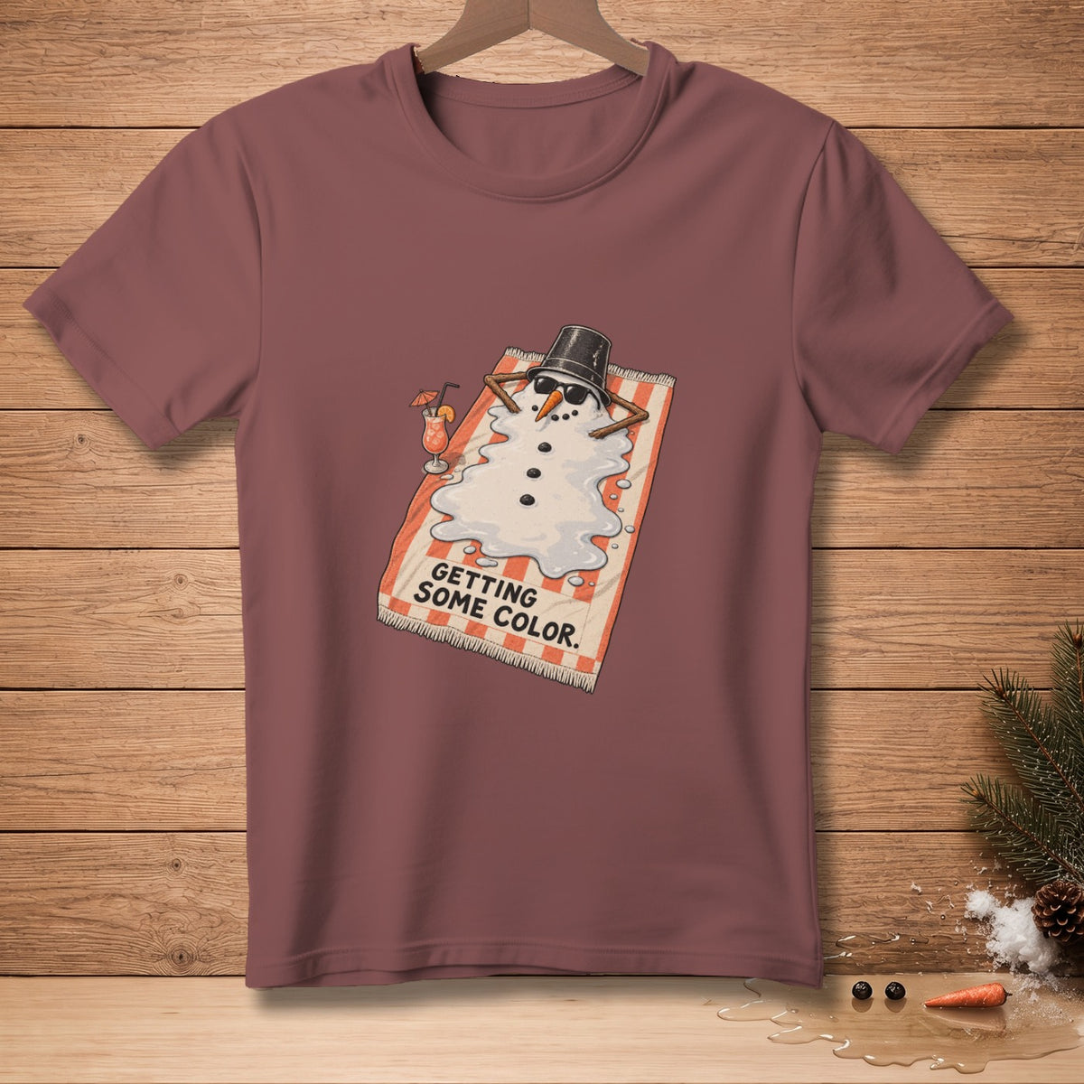T-shirt with melting snowman wearing sunglasses and a hat, with text.