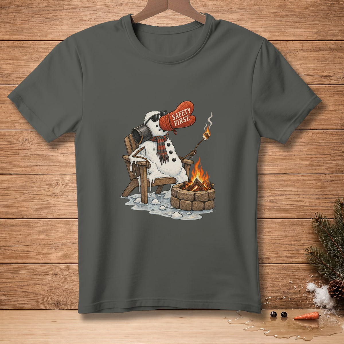 Melting snowman in chair roasts marshmallow over campfire, wearing oven mitt with "Safety First" text.