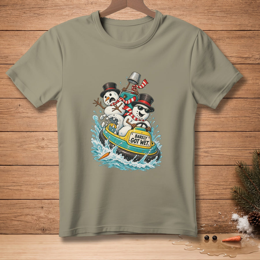 Three snowmen in a boat with "Barely Got Wet" text on a light green t-shirt.
