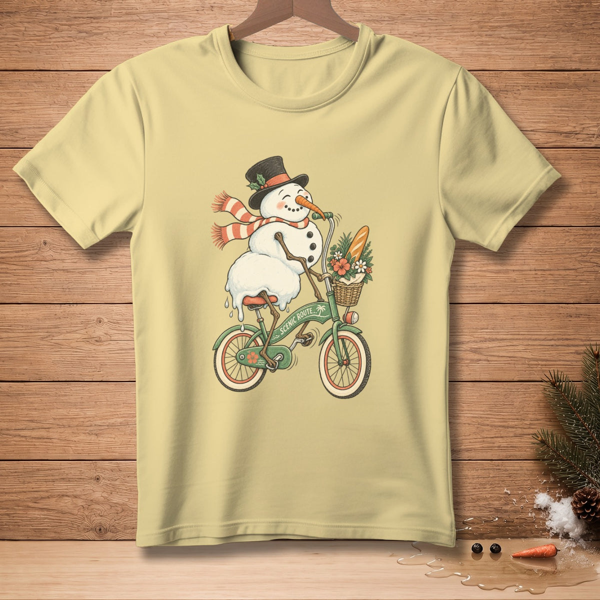 Snowman wearing a hat and scarf rides a bicycle with a basket of flowers and bread.