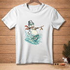 White t-shirt with a snowman surfing on a surfboard with "Still Up" text.