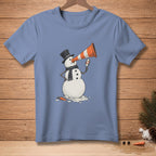 Snowman in top hat and scarf holds orange cone to eye, looks in mirror.