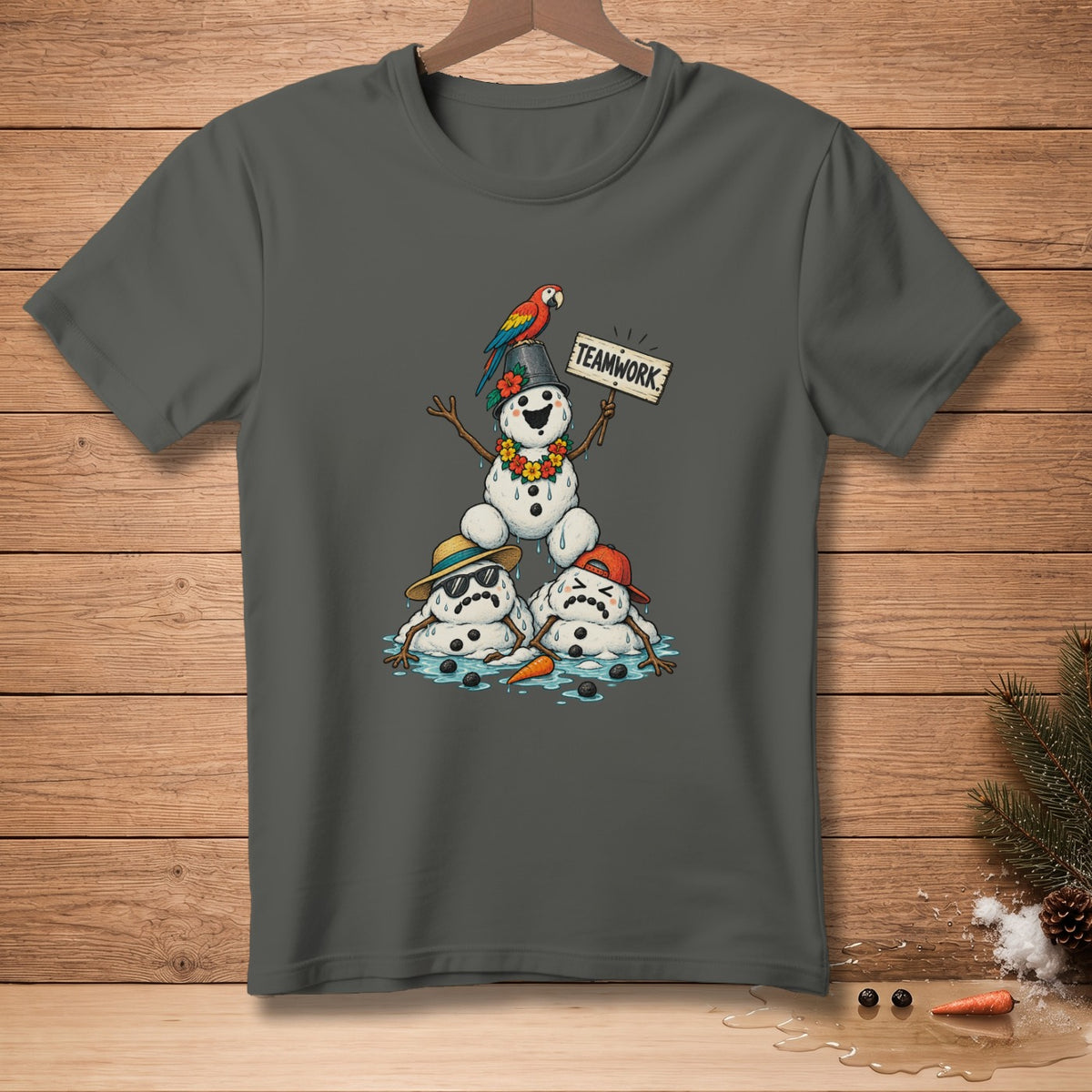 Melting snowmen with a parrot and a "TEAMWORK" sign on a gray t-shirt.