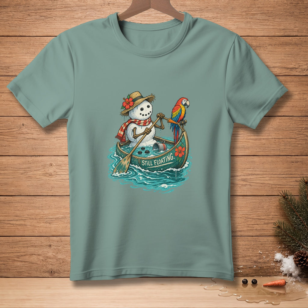 Snowman in a canoe with a parrot, paddle, and text "STILL FLOATING."