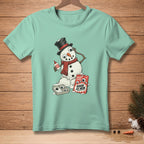 Snowman with glue and googly eyes, on a teal t-shirt.
