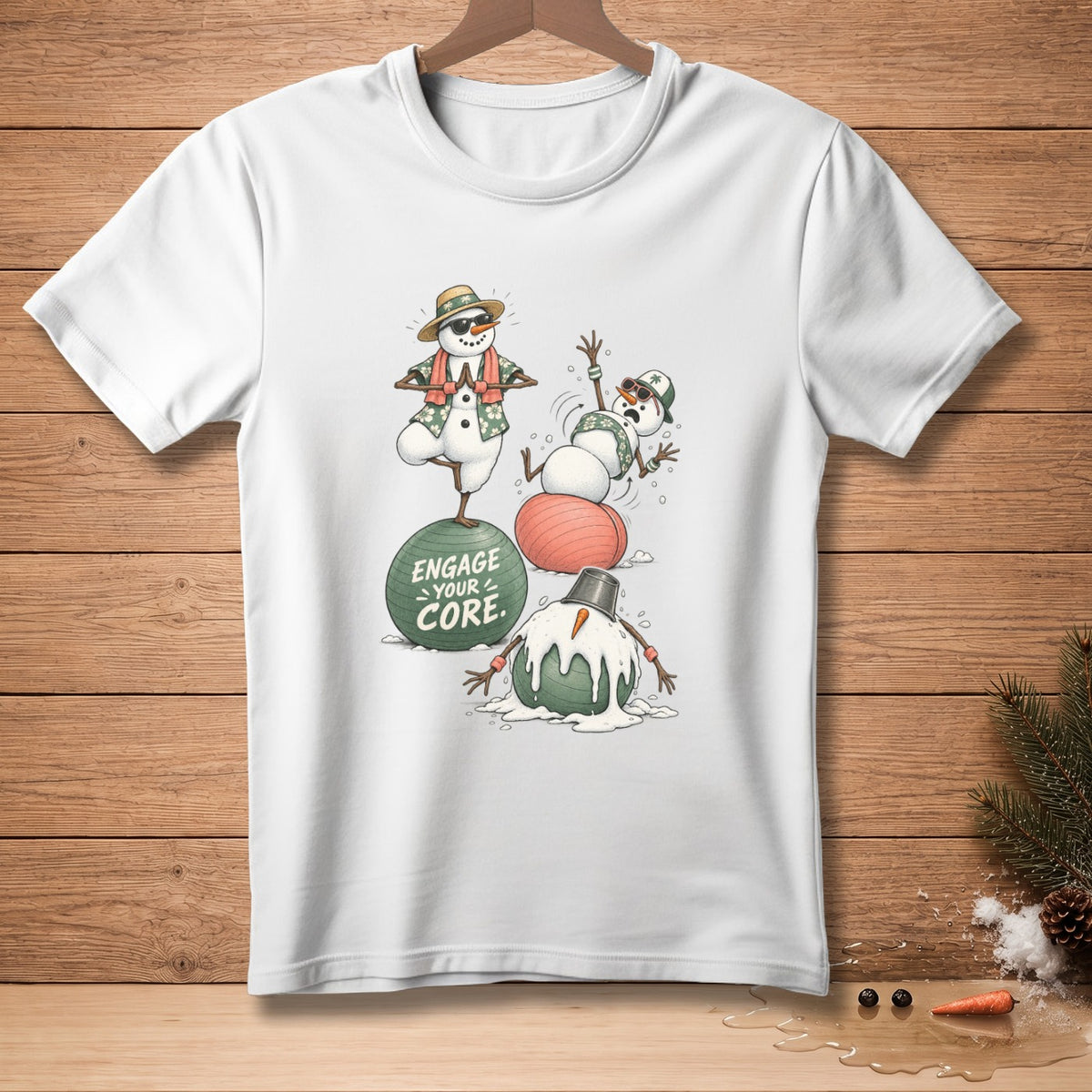 Three snowmen doing yoga with text "ENGAGE YOUR CORE" on a t-shirt.
