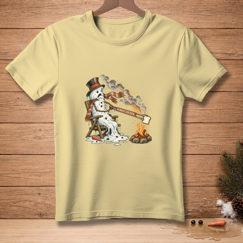 Melting snowman sitting in a chair by a campfire, toasting bread with text "ALMOST GOLDEN."