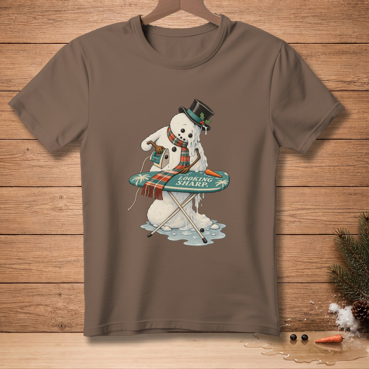 Melting snowman ironing with "LOOKING SHARP" text on an ironing board.
