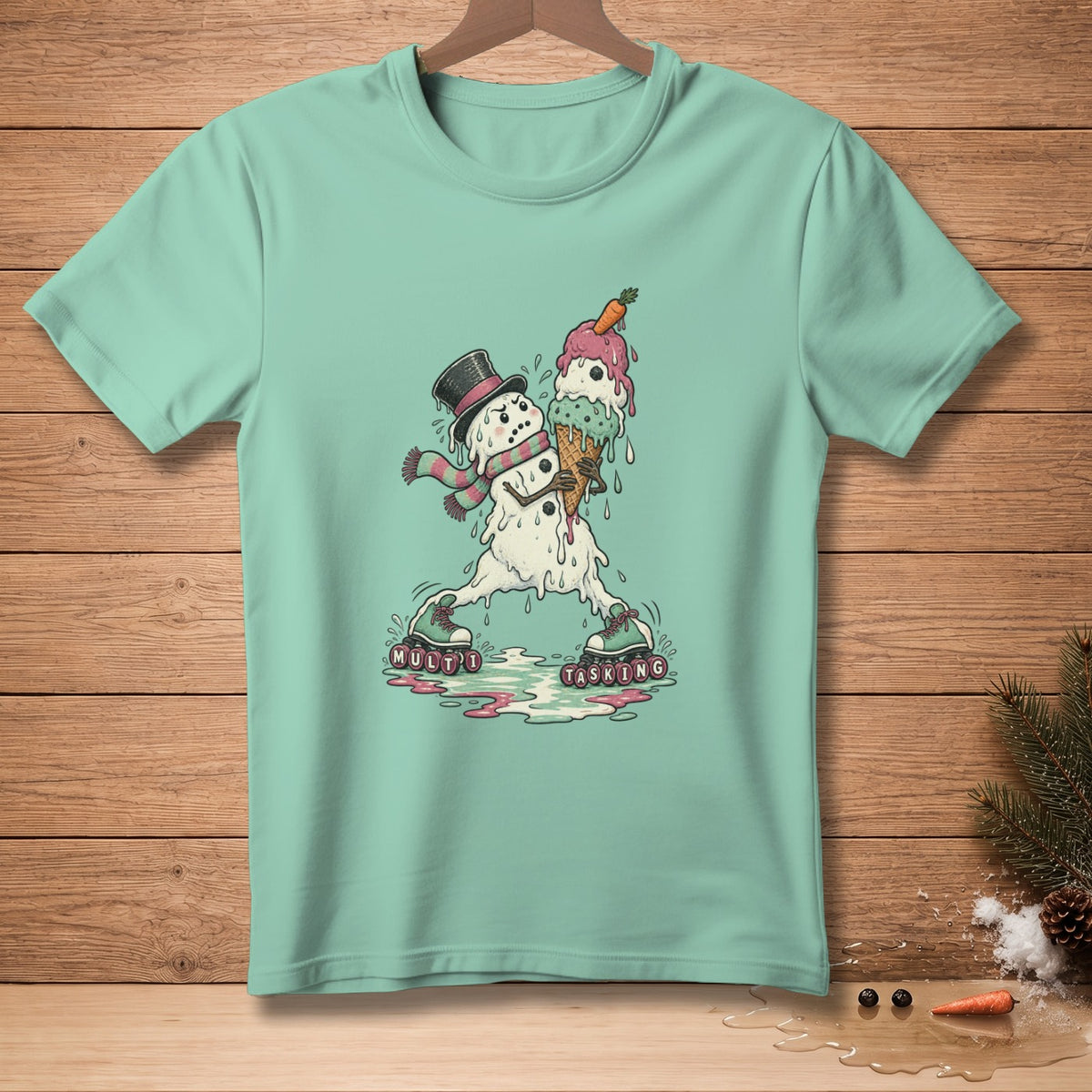 Mint green t-shirt with a melting snowman holding ice cream, wearing a top hat and scarf.