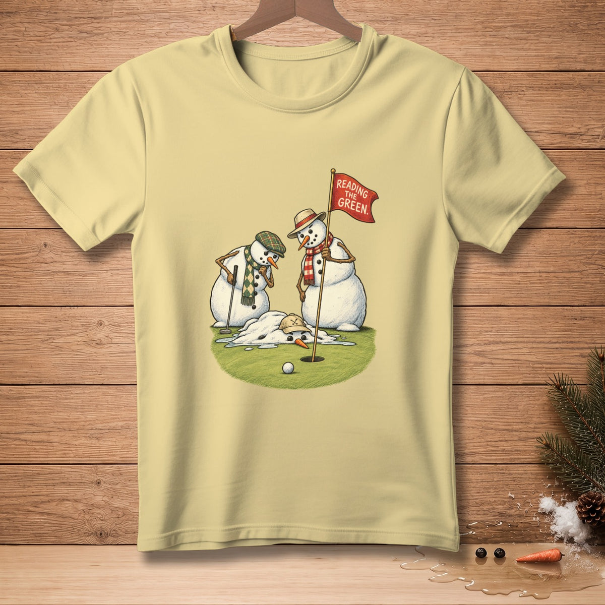 Two snowmen on a golf course, one melting, with a flag reading "Reading the Green".