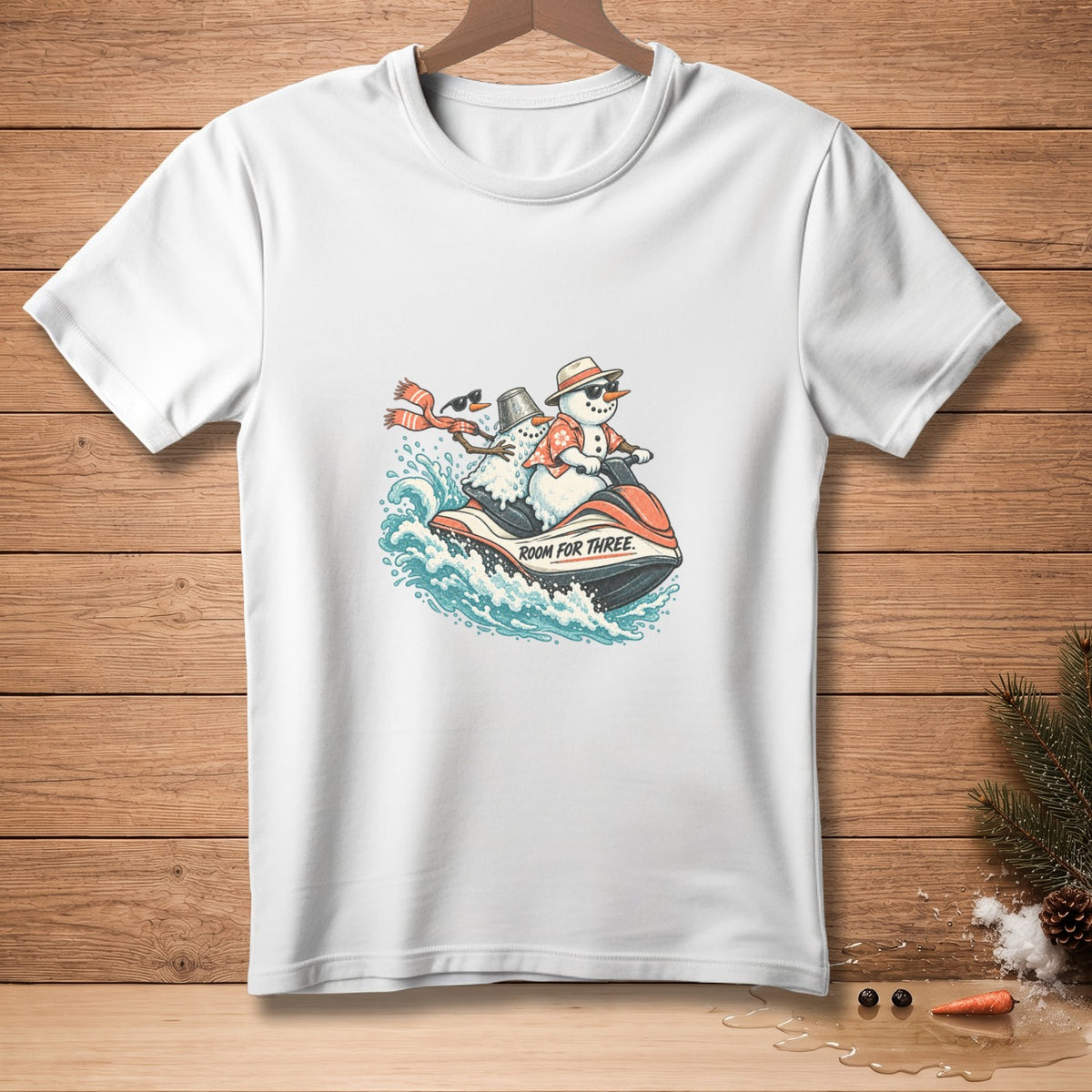 White t-shirt with graphic of snowmen riding a jet ski with text "ROOM FOR THREE".