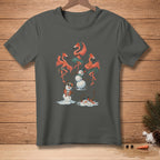 Flamingos in grass skirts dance with melting snowmen on a dark gray t-shirt.