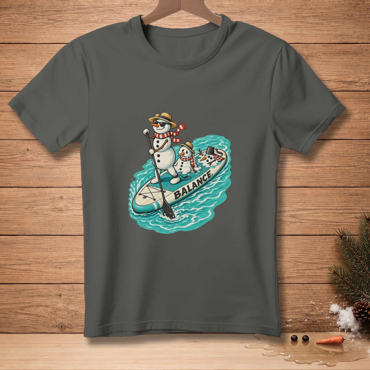 Snowmen on a paddleboard with the word "BALANCE" on the board.