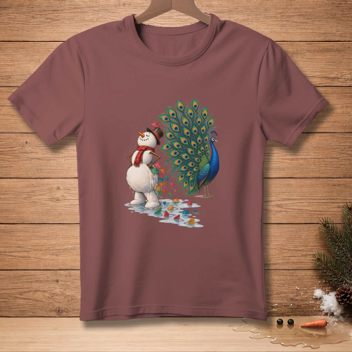 Snowman with a peacock, scattered tiny umbrellas, and melting puddles on a maroon t-shirt.