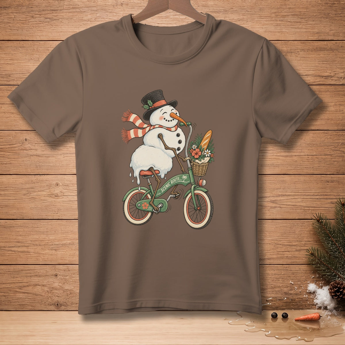 Snowman in a top hat and scarf rides a bicycle with a basket of flowers and bread.