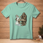Bigfoot playing rock paper scissors with a melting snowman, text "BEST TWO OUT OF THREE".