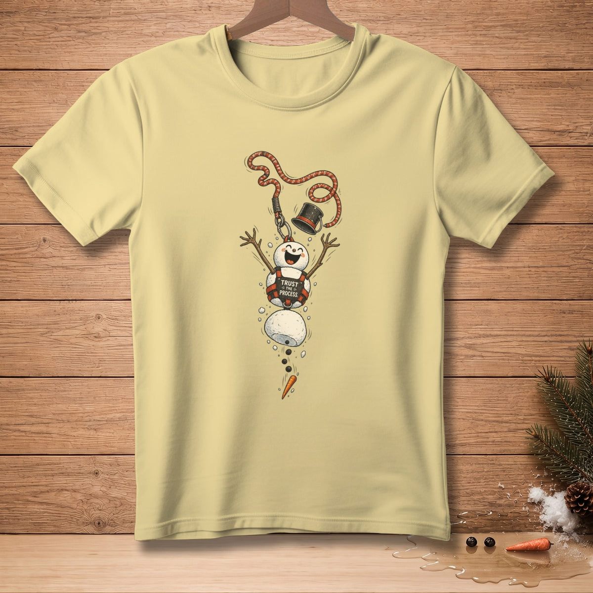 Light yellow t-shirt with melting snowman graphic and "TRUST THE PROCESS" text.