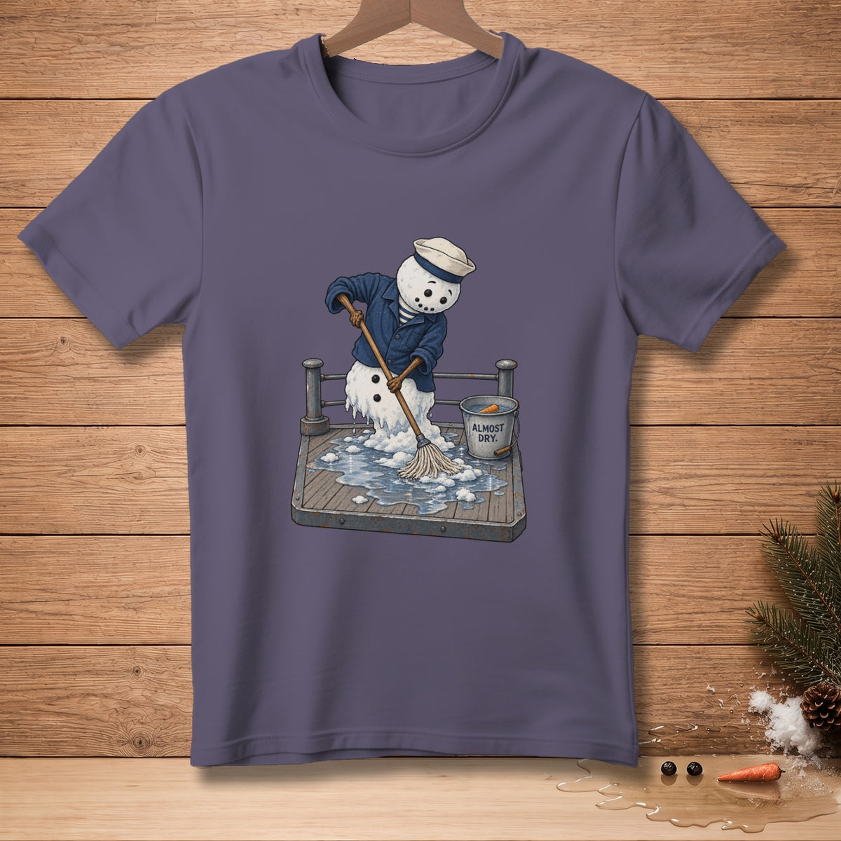 Snowman in sailor uniform mopping up a puddle, bucket reads "ALMOST DRY".