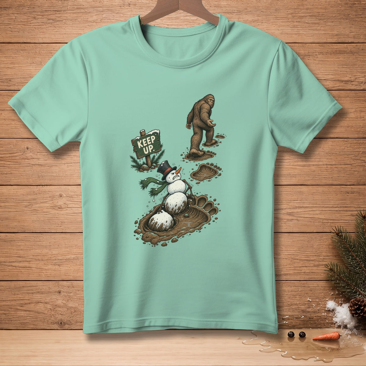 Bigfoot walking past a snowman in mud next to a "Keep Up" sign.