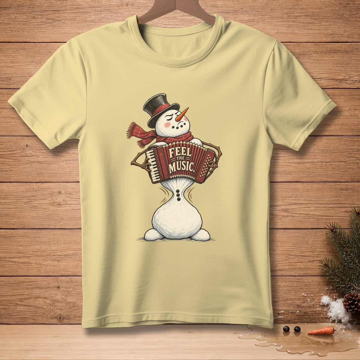Yellow t-shirt with snowman playing accordion and "Feel the Music" text.