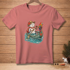 Snowman in a canoe with a parrot, text "STILL FLOATING" on shirt.