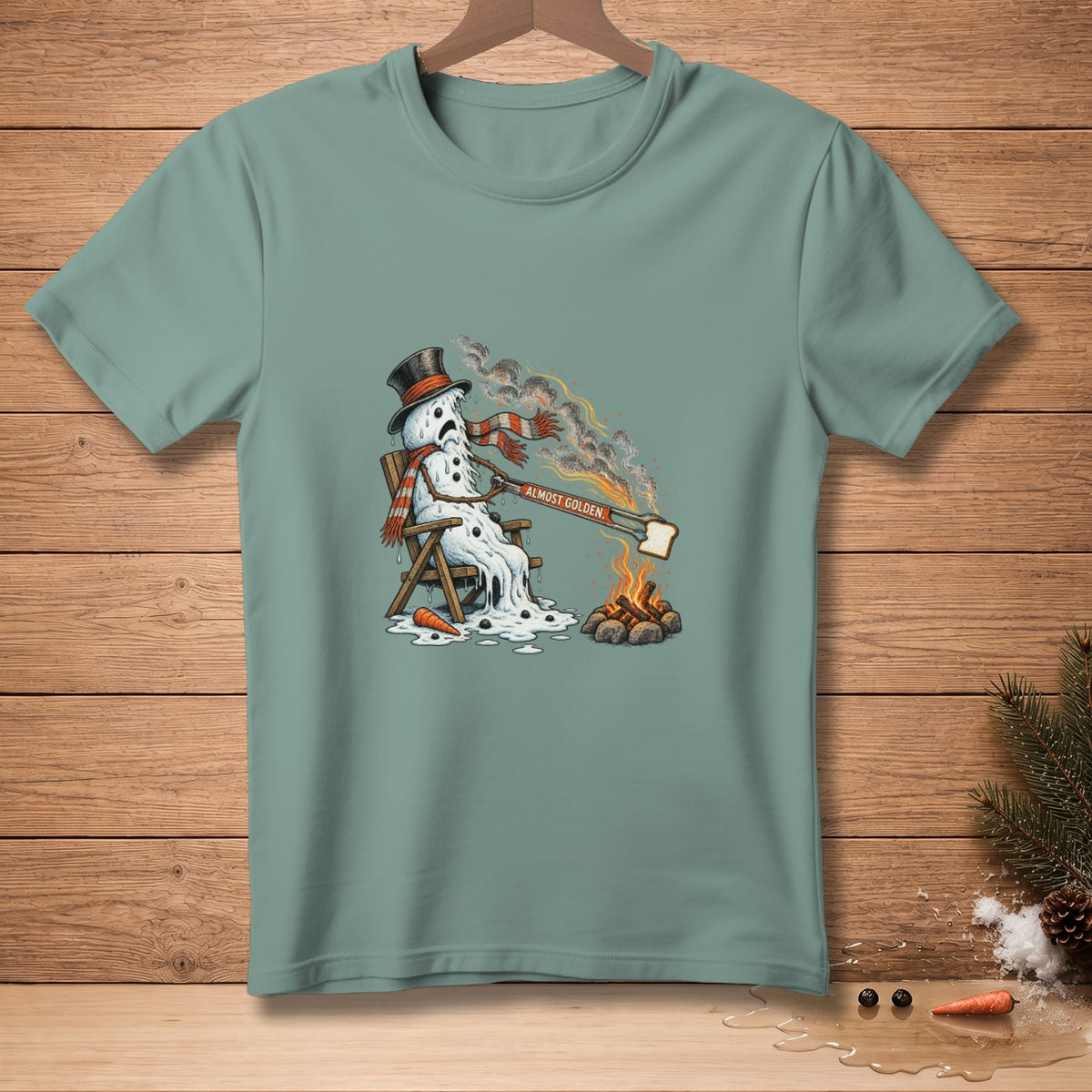 Melting snowman in top hat and scarf toasting bread over campfire, "ALMOST GOLDEN."