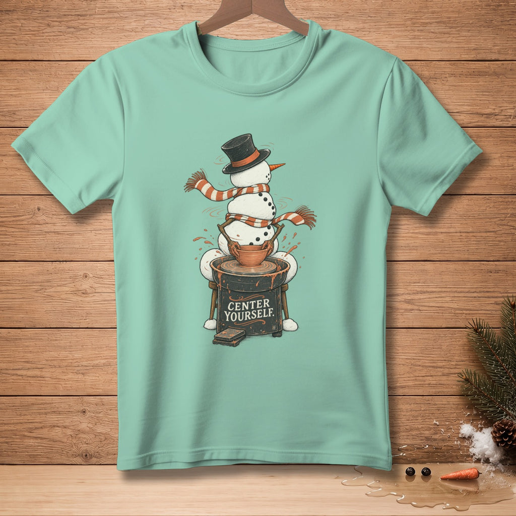 Snowman wearing hat and scarf on pottery wheel with text "CENTER YOURSELF."